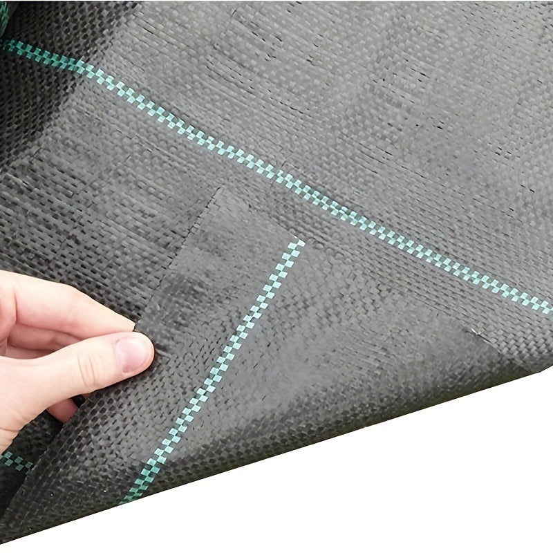 Rouleau de tissu paysager noir en PP non tissé, bordures vertes, durable, bloque les mauvaises herbes, perméable à l’eau, idéal potager et massifs floraux.