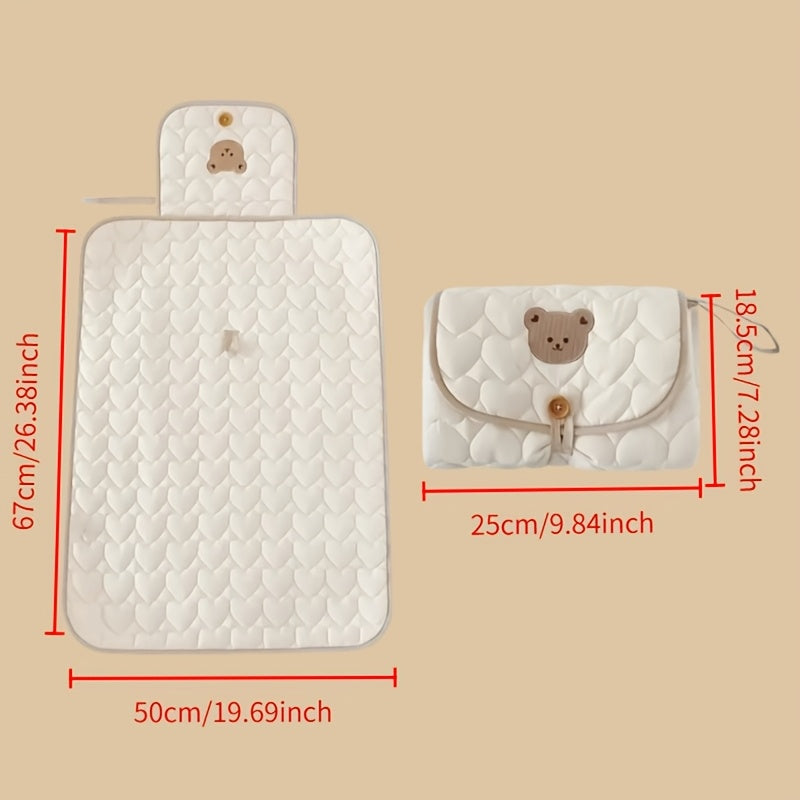 Portable changing mat with cream bear pattern, foldable, breathable polyester, adjustable strap, ideal for short trips.