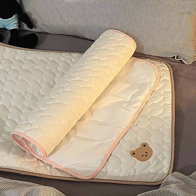 Portable changing mat with cream bear pattern, foldable, breathable polyester, adjustable strap, ideal for short trips.