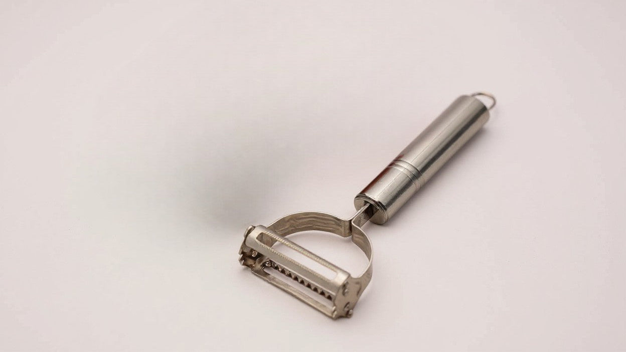 Multifunctional stainless steel peeler and slicer, sharp blade, for potatoes, carrots, ergonomic handle, easy and efficient preparation, durable design.