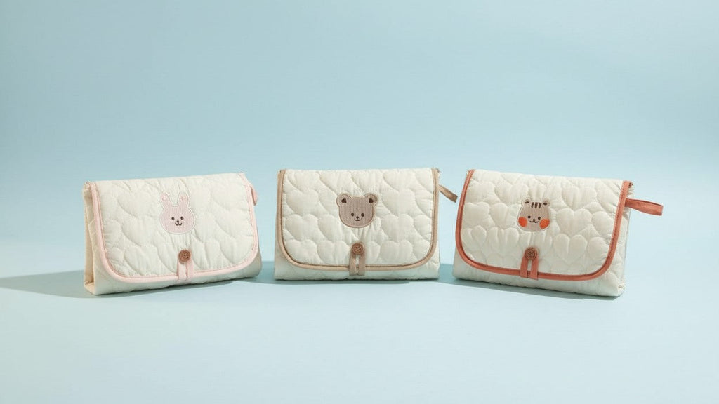 Portable changing mat with cream bear pattern, foldable, breathable polyester, adjustable strap, ideal for short trips.